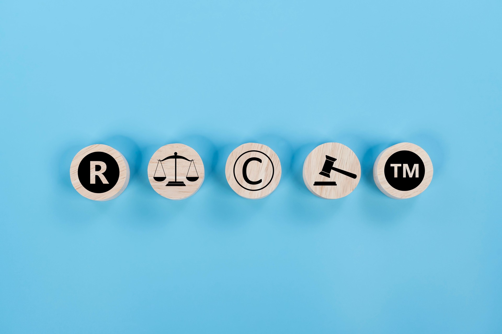 Copyright symbol or intellectual property rights of patentee on wooden cube.